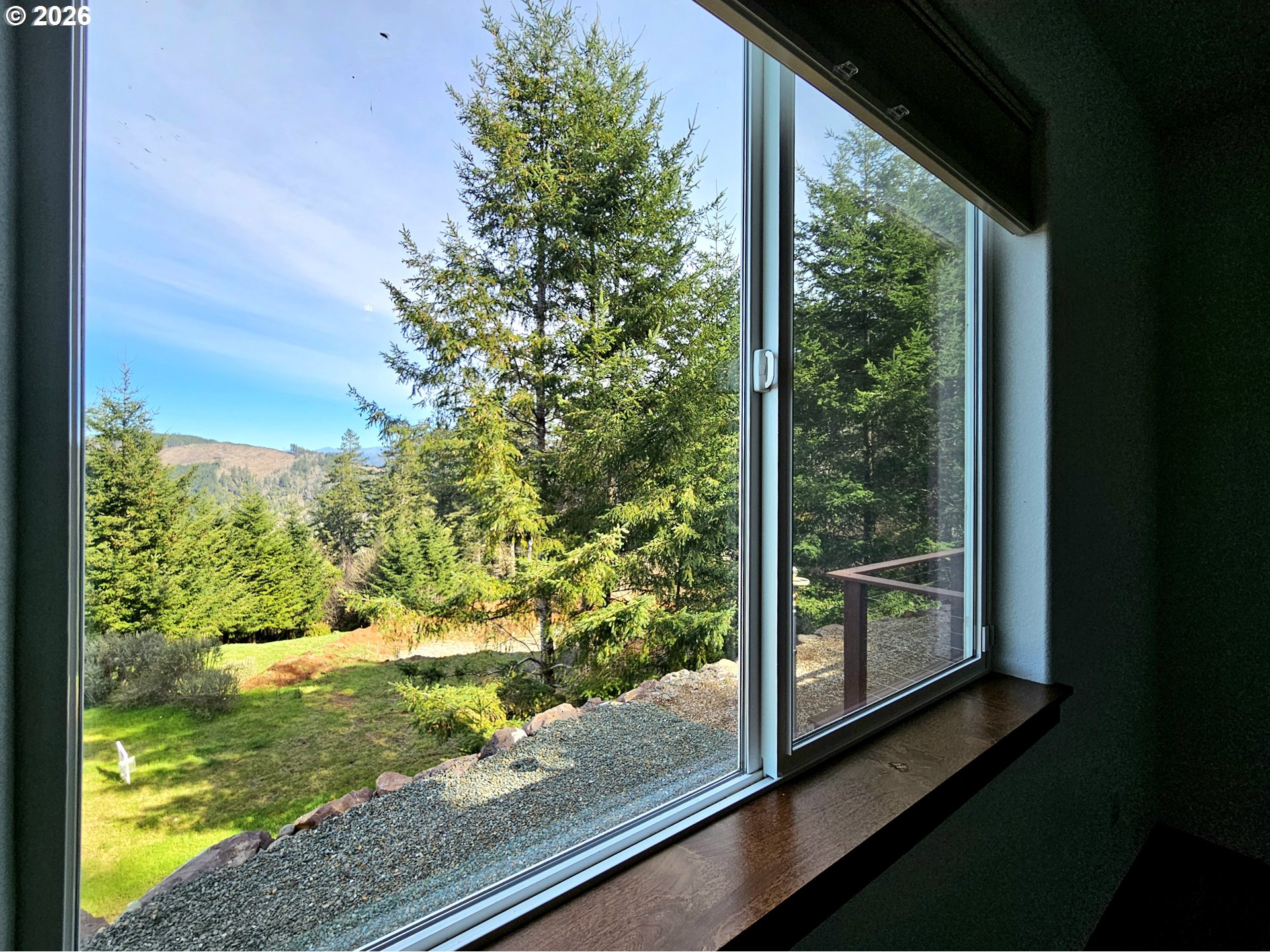 98205 Sunforest Court Brookings, OR 97415 - Photo 21 of 45 a view of a yard from a window