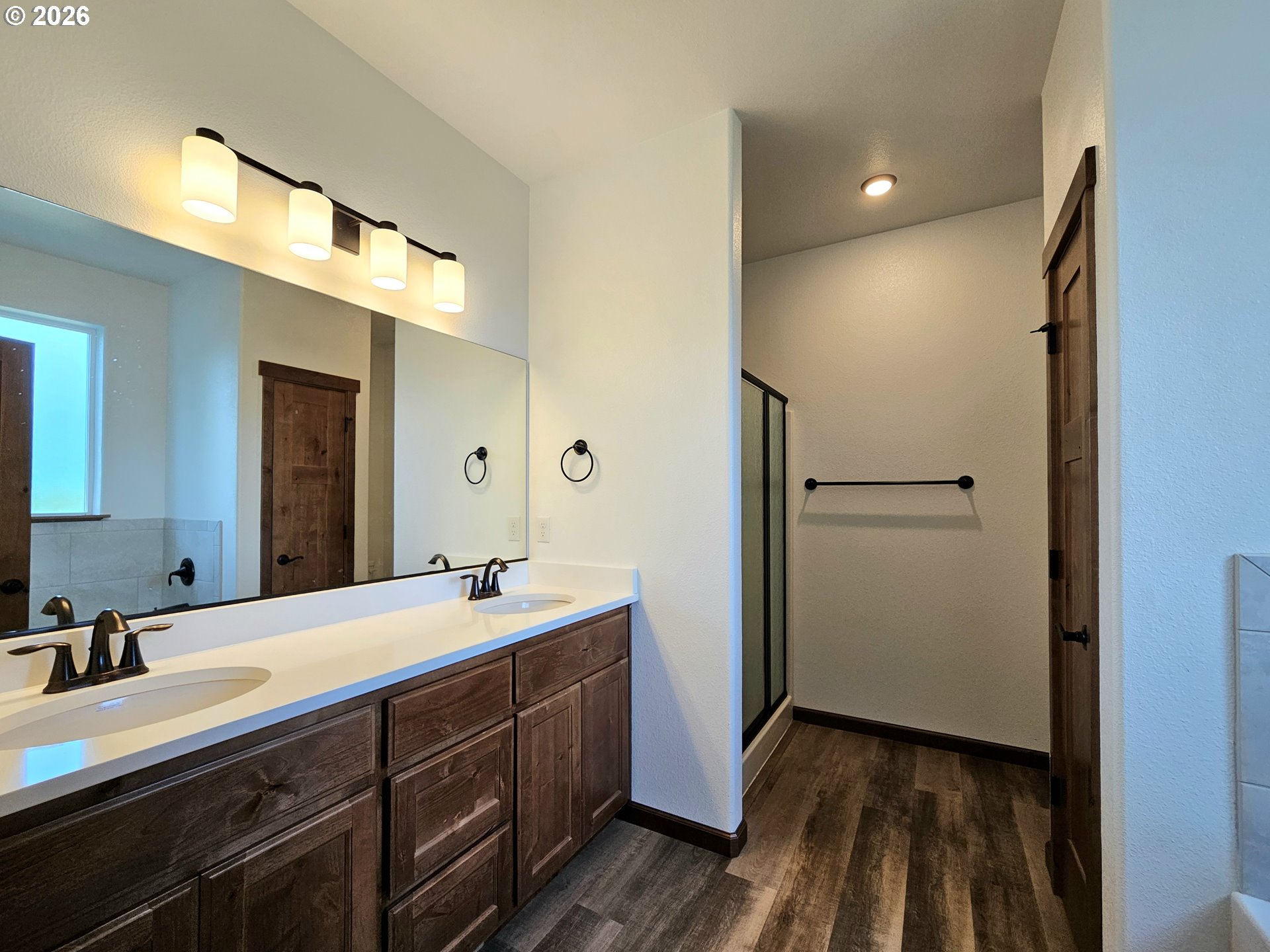 98205 Sunforest Court Brookings, OR 97415 - Photo 25 of 45 a spacious bathroom with a double vanity sink and mirror