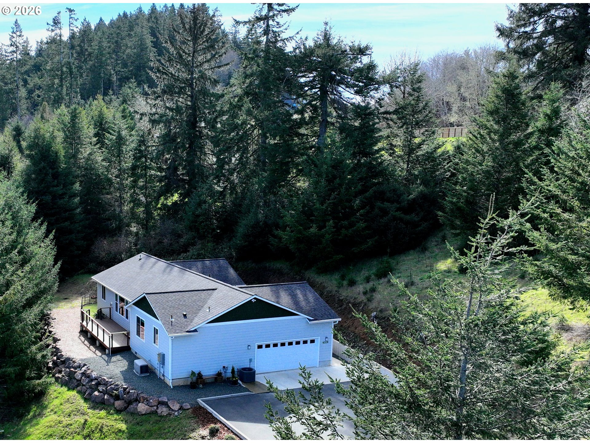 98205 Sunforest Court Brookings, OR 97415 - Photo 3 of 45 an aerial view of a house with yard and outdoor seating