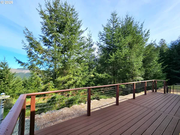 a view of balcony with wooden floor and fence