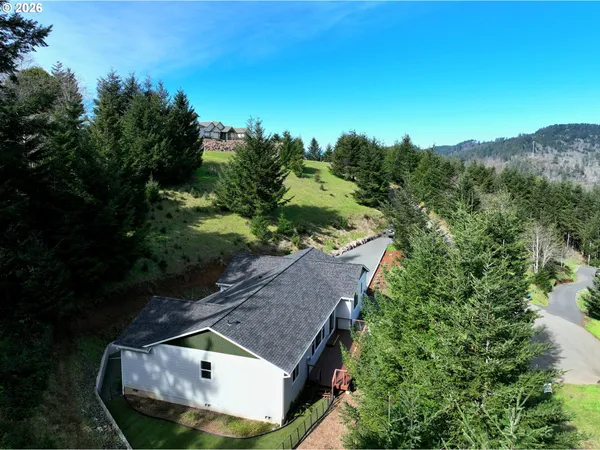 an aerial view of a house with a yard