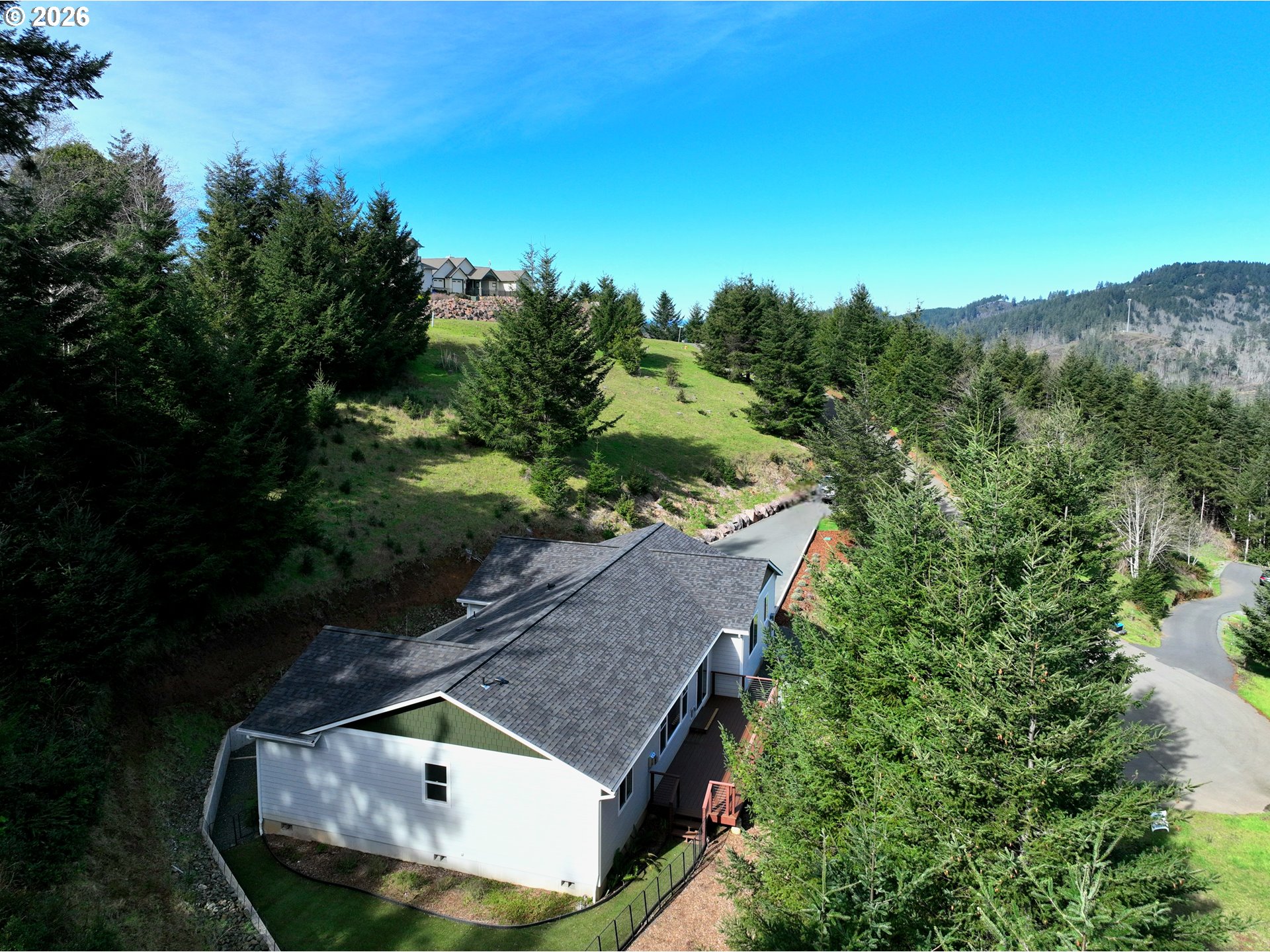 98205 Sunforest Court Brookings, OR 97415 - Photo 4 of 45 an aerial view of a house with a yard