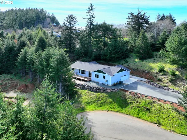 an aerial view of a house with a yard