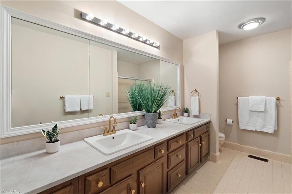 3619 Gramercy Road Greensboro, NC 27410 - Photo 28 of 49 Huge hall bath shared by Bedrooms 2 & 3 with 2 new sinks, countertops and hardware.