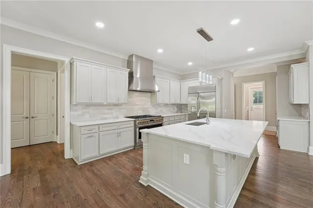 an empty room with wooden floor chandelier fan and windows