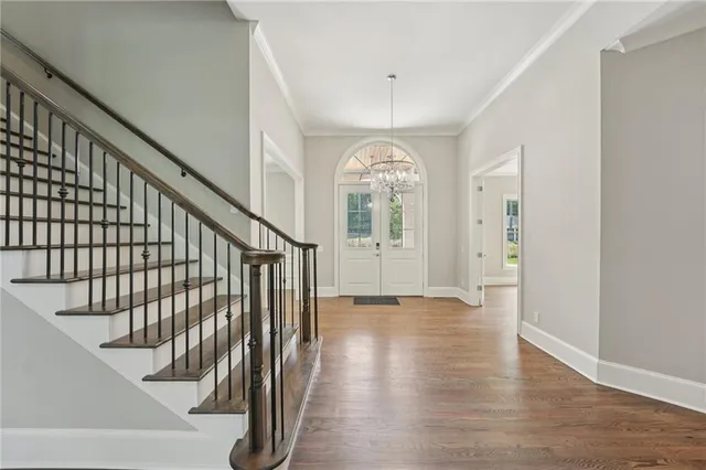 a view of entryway and hall with wooden floor