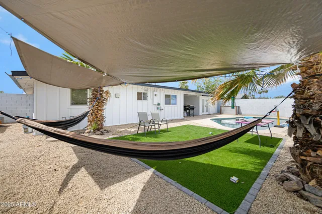 a view of a backyard with plants and a patio