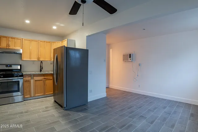 a kitchen with stainless steel appliances a refrigerator and a stove top oven