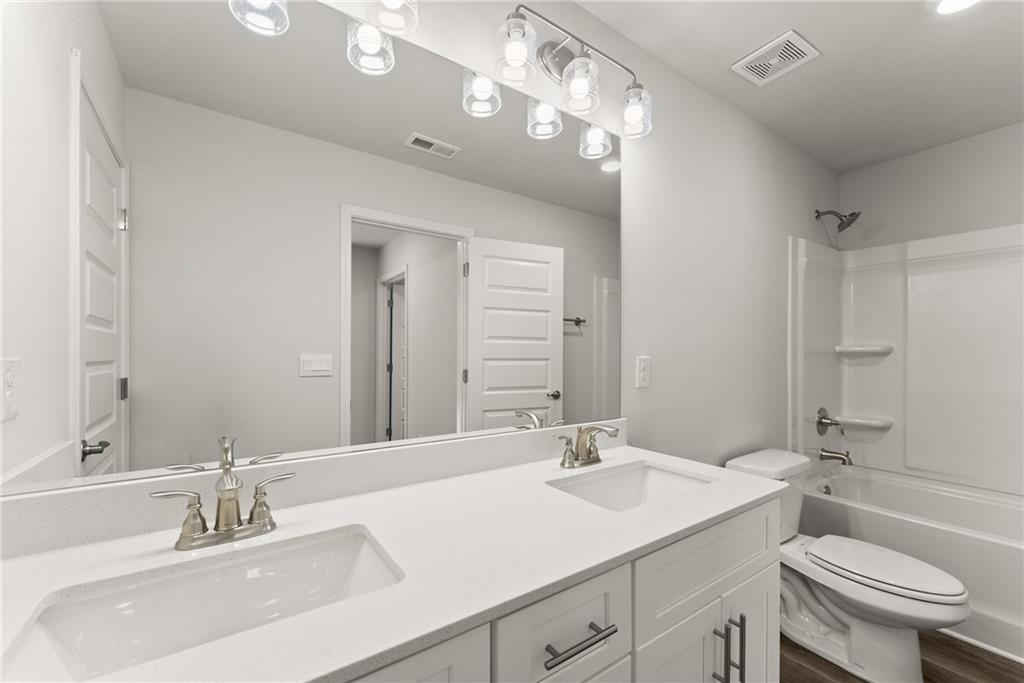 478 Magnolia Grove Place Cornelia, GA 30531 - Photo 24 of 38 a bathroom with a sink double vanity and a toilet