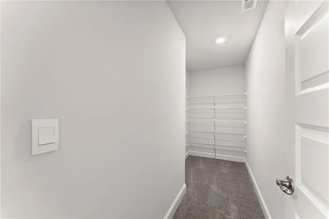 a view of an empty room with a ceiling fan