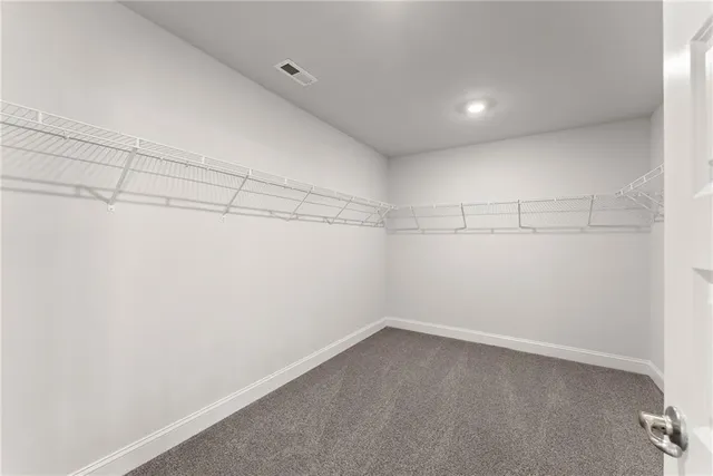 a spacious bathroom with a double vanity sink a mirror and a shower