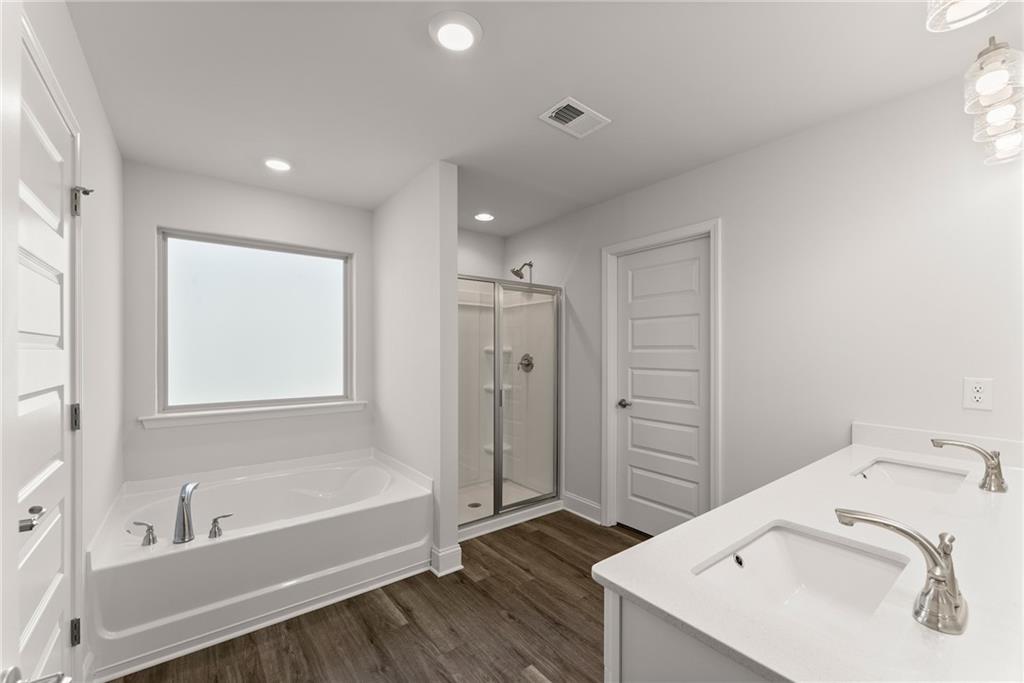 478 Magnolia Grove Place Cornelia, GA 30531 - Photo 36 of 38 a bathroom with a sink a bathtub and a shower