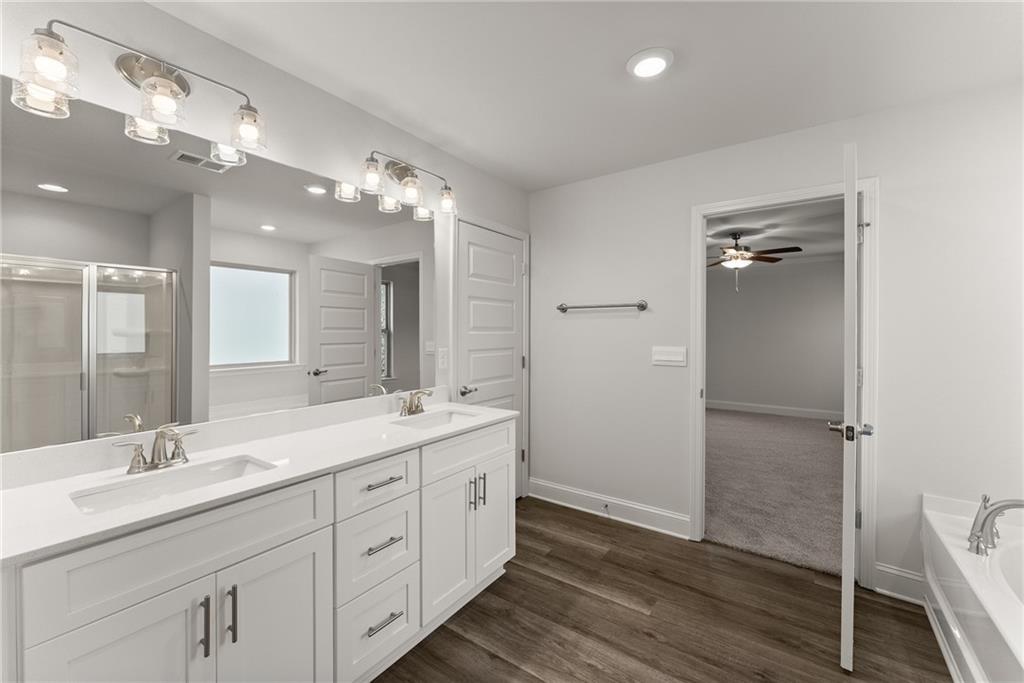 478 Magnolia Grove Place Cornelia, GA 30531 - Photo 38 of 38 a spacious bathroom with a double vanity sink a mirror and a shower
