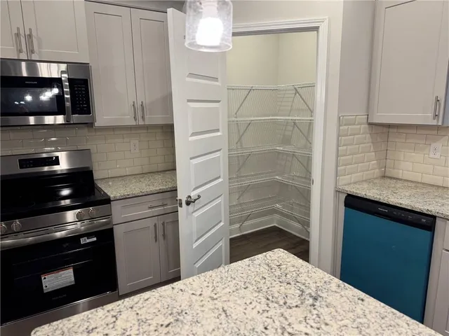 a kitchen with a stove and a microwave