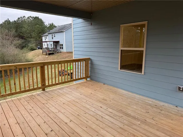 a view of a balcony with wooden floor