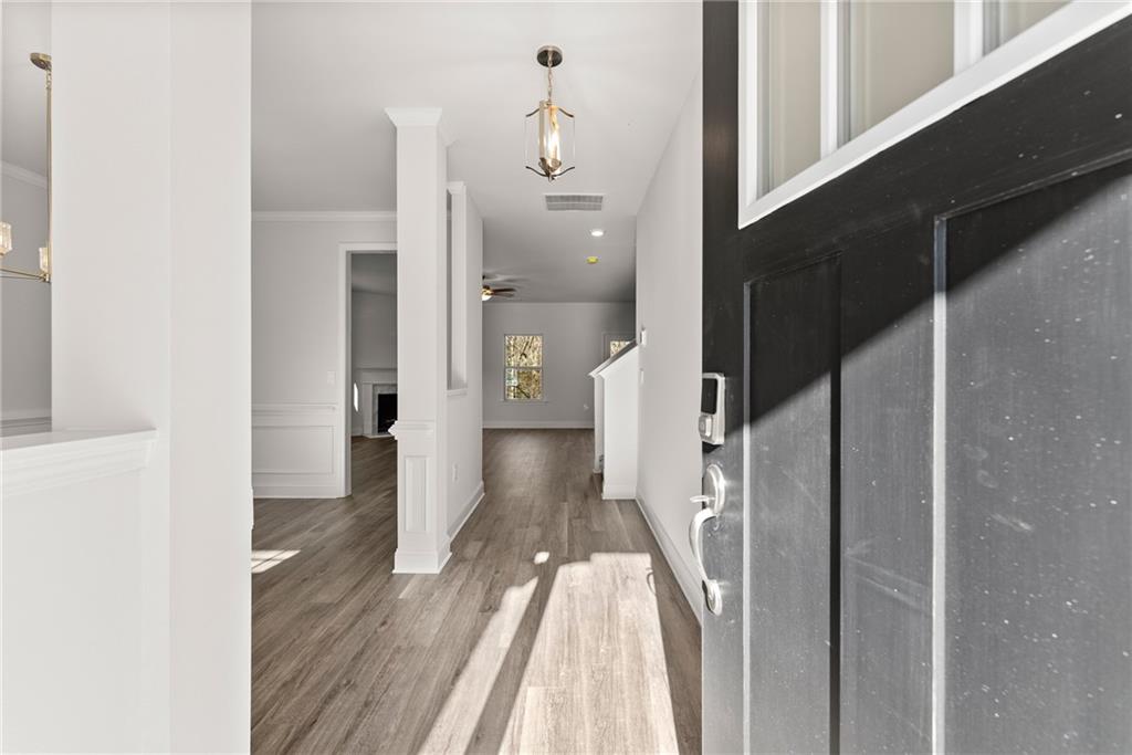 478 Magnolia Grove Place Cornelia, GA 30531 - Photo 8 of 38 a view of a hallway with wooden floor and staircase