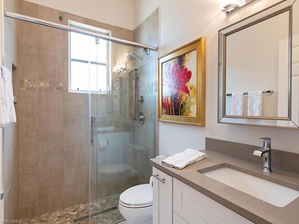 901 Marblehead Drive, Unit B1 Naples, FL 34104 - Photo 11 of 13 a bathroom with a granite countertop sink a toilet and shower