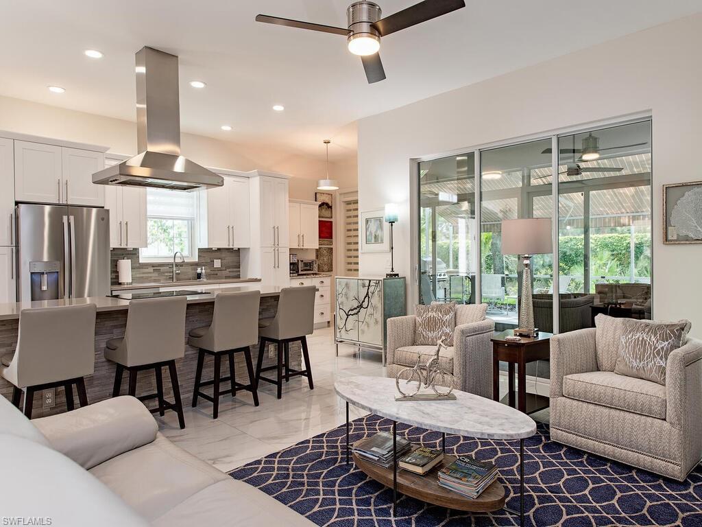 901 Marblehead Drive, Unit B1 Naples, FL 34104 - Photo 3 of 13 a living room with furniture and a large window