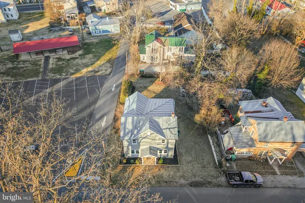an aerial view of a houses with yard