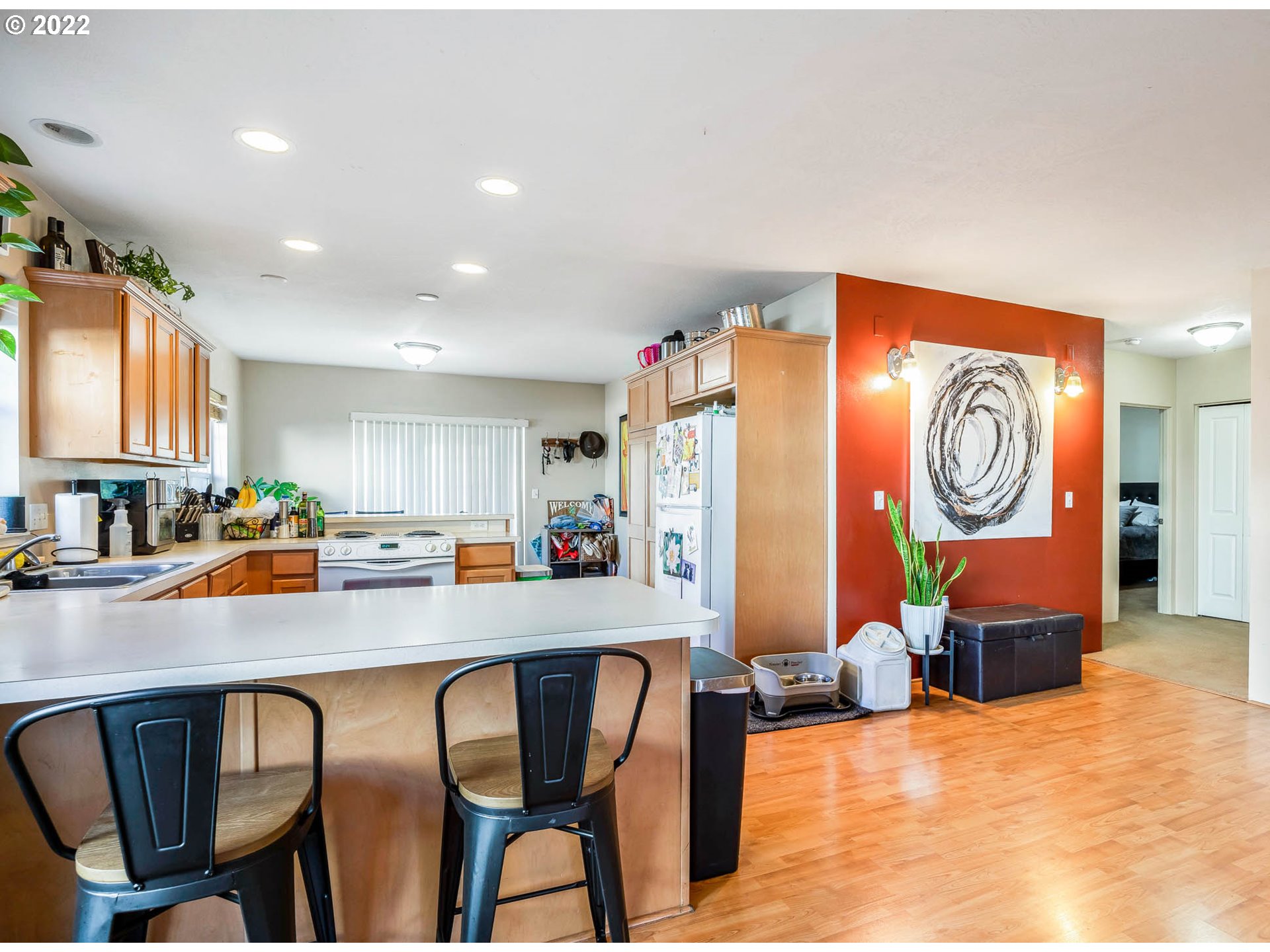 1849 8th Street Springfield, OR 97477 - Photo 11 of 32 a kitchen with stainless steel appliances a table and chairs in it