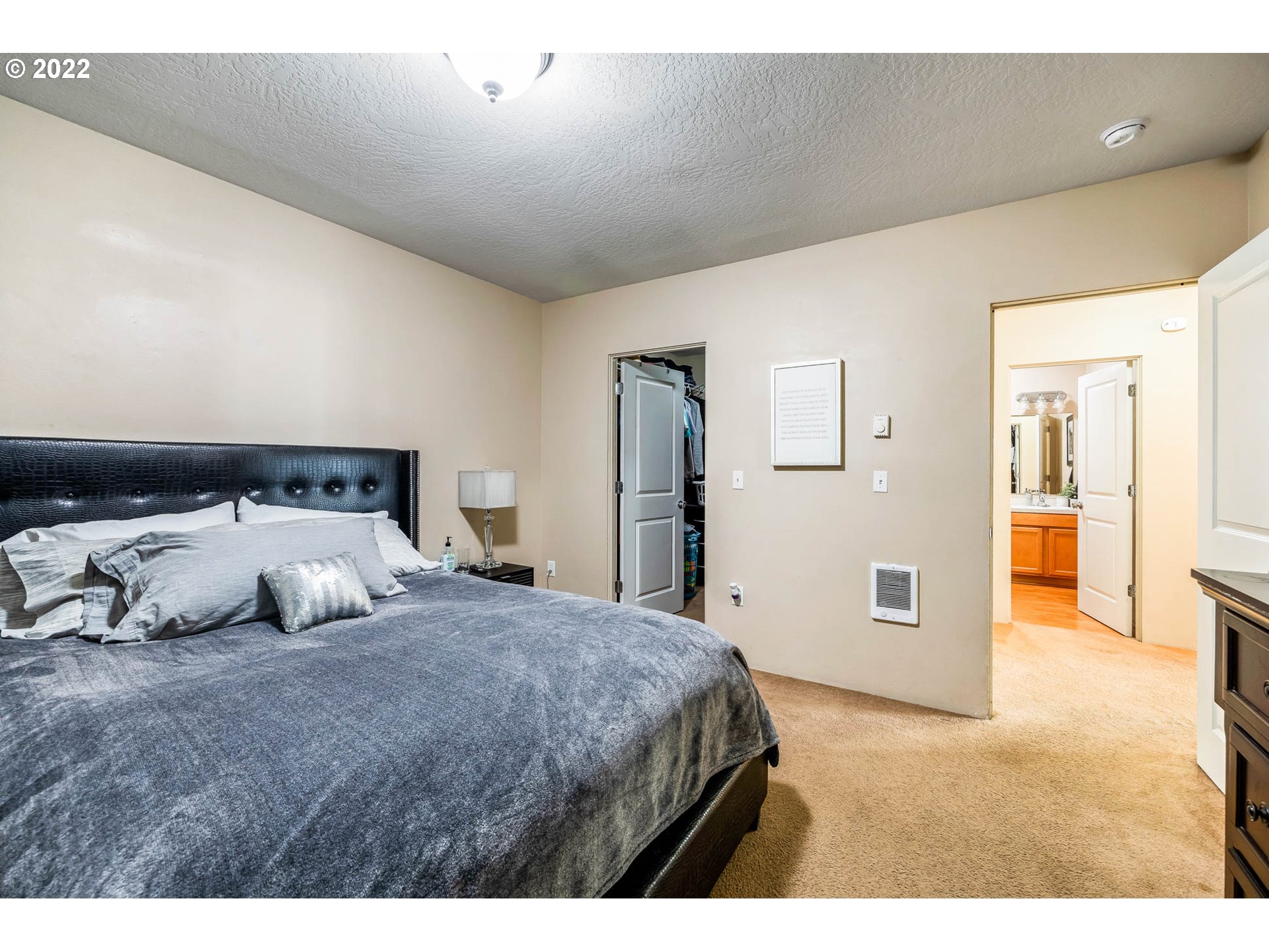 1849 8th Street Springfield, OR 97477 - Photo 14 of 32 a bedroom with a large bed and a chandelier