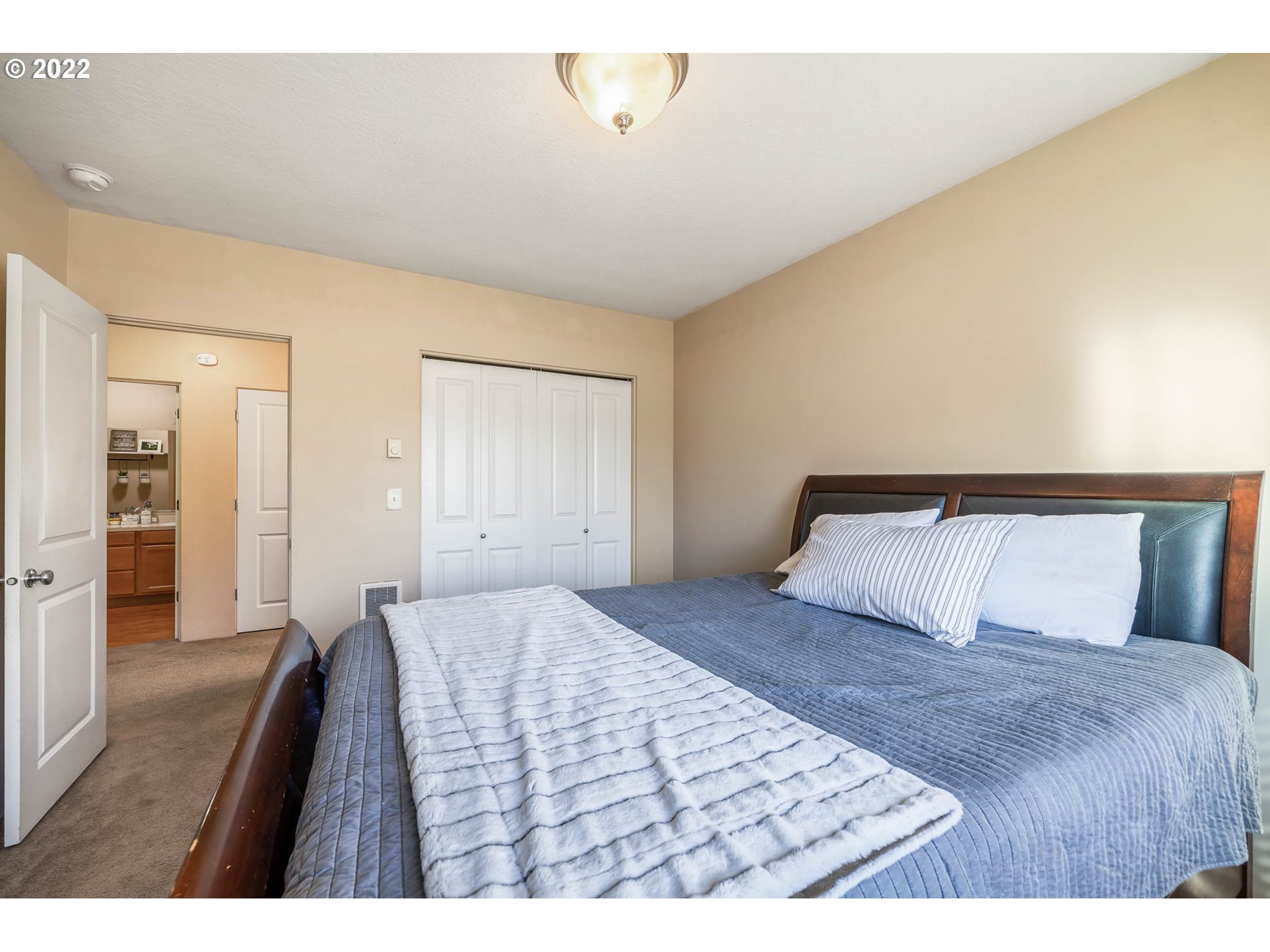 1849 8th Street Springfield, OR 97477 - Photo 18 of 32 a bedroom with a large bed and a chandelier