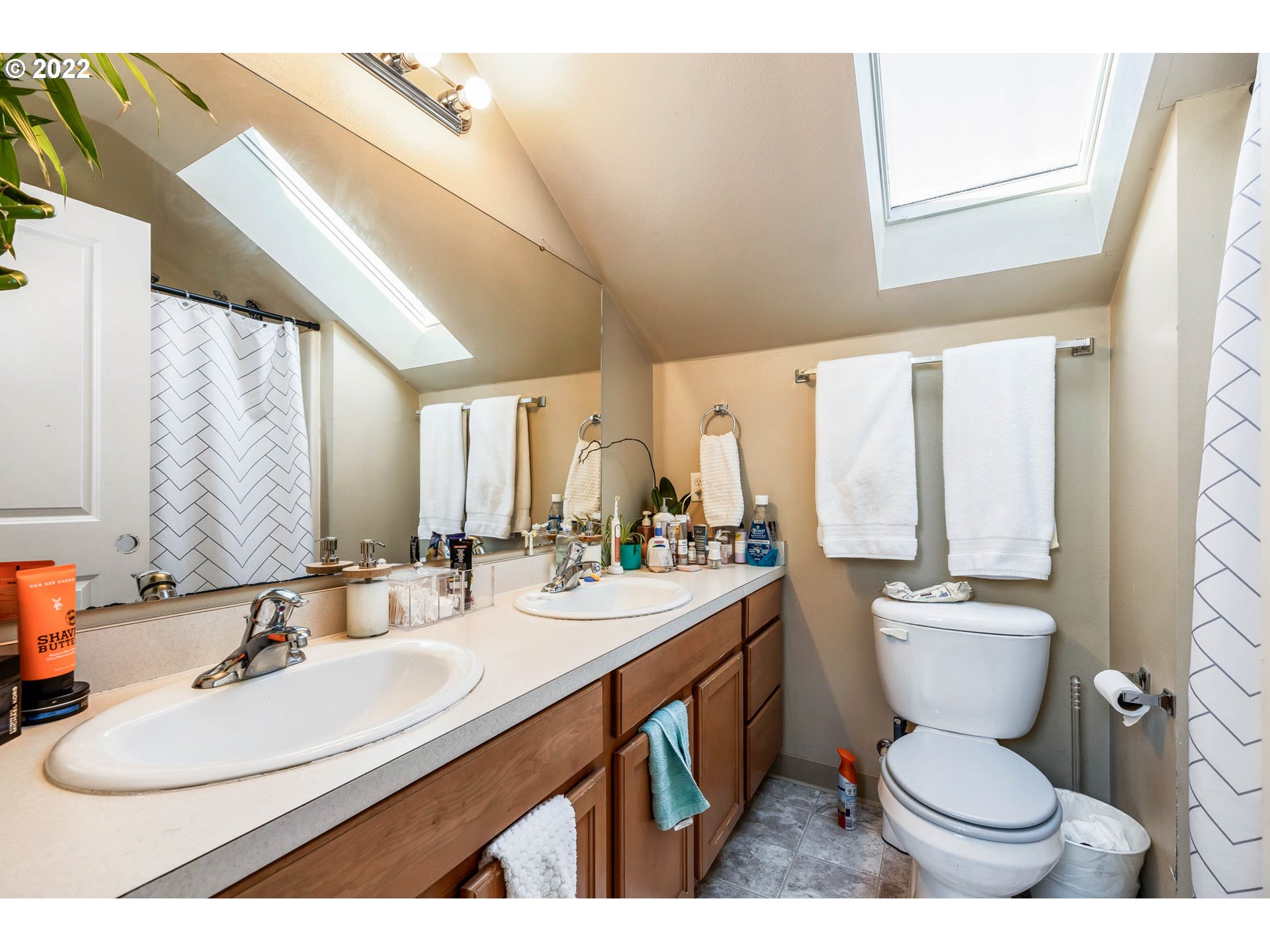 1849 8th Street Springfield, OR 97477 - Photo 30 of 32 a bathroom with a double vanity sink toilet and a mirror