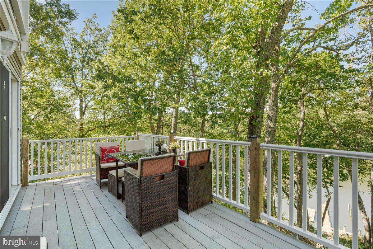 219 Calvert Drive Lusby, MD 20657 - Photo 15 of 51 a balcony with wooden floor and outdoor space