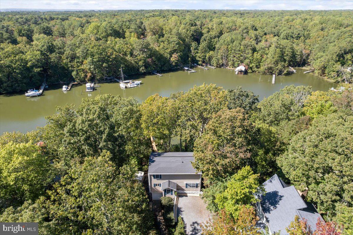 219 Calvert Drive Lusby, MD 20657 - Photo 2 of 51 an aerial view of a house with a yard and lake view