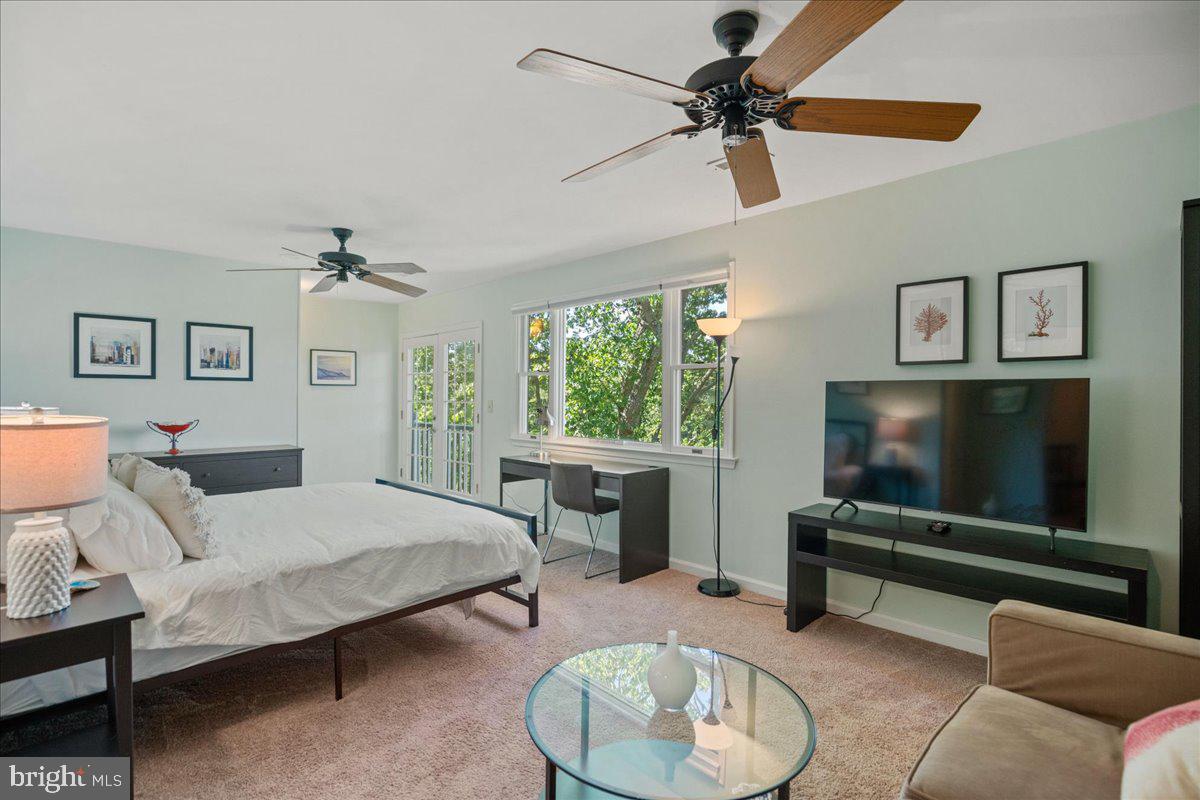 219 Calvert Drive Lusby, MD 20657 - Photo 27 of 51 a bedroom with a bed and a chandelier