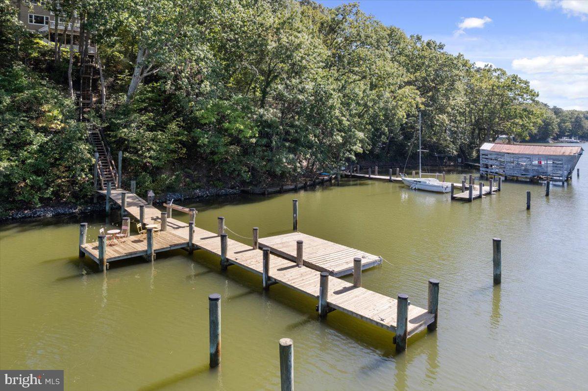 219 Calvert Drive Lusby, MD 20657 - Photo 3 of 51 a view of a lake with couches chairs