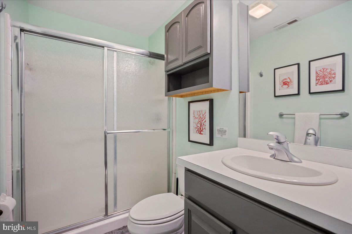 219 Calvert Drive Lusby, MD 20657 - Photo 31 of 51 a bathroom with a granite countertop sink toilet and shower