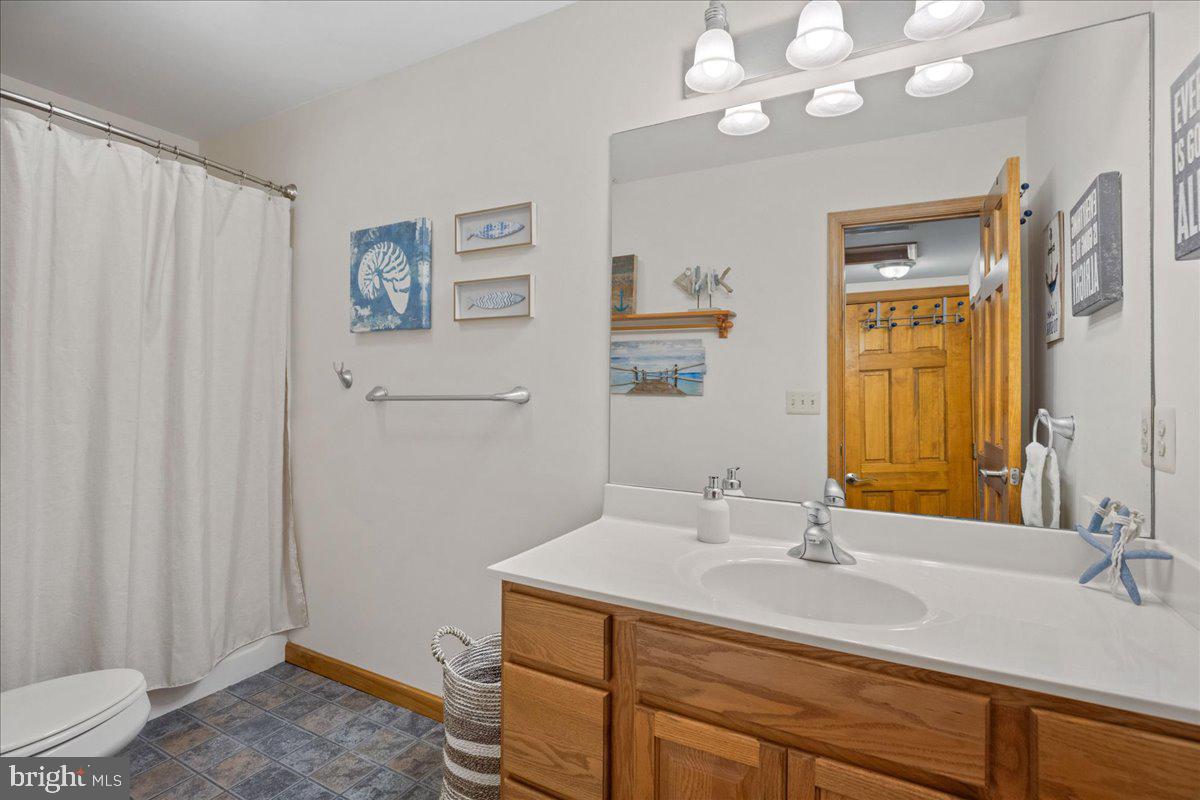 219 Calvert Drive Lusby, MD 20657 - Photo 35 of 51 a bathroom with a sink a vanity and a mirror
