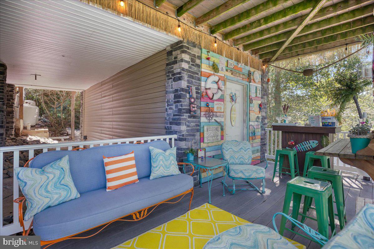 219 Calvert Drive Lusby, MD 20657 - Photo 43 of 51 a outdoor living space with furniture and a fireplace