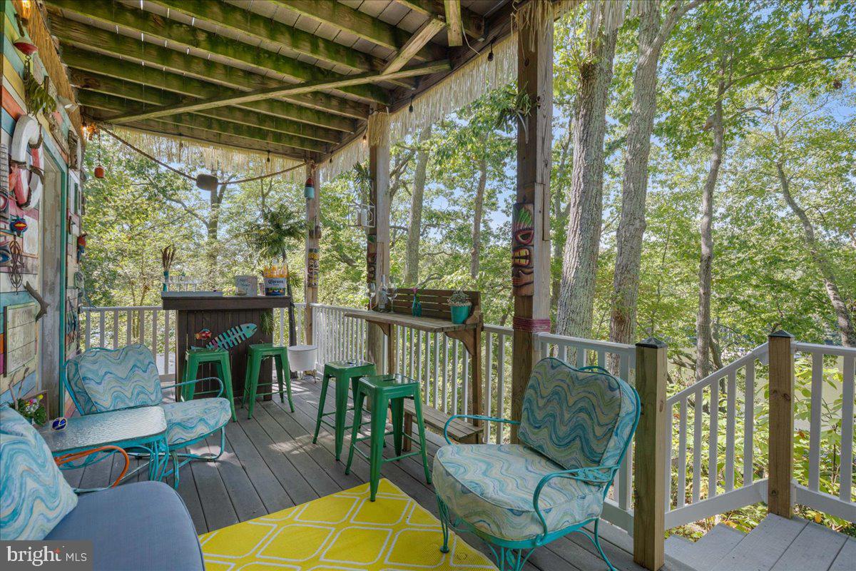 219 Calvert Drive Lusby, MD 20657 - Photo 44 of 51 a view of a patio with couches chairs and a potted plant