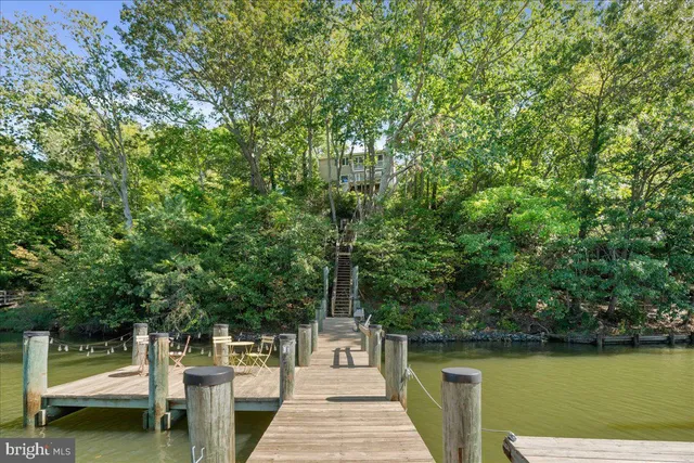 a view of a lake with a table and chairs