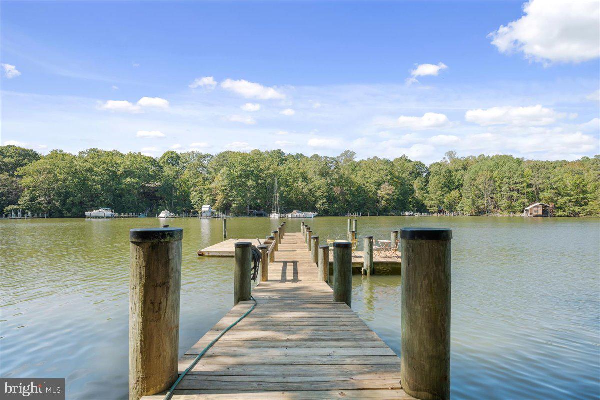 219 Calvert Drive Lusby, MD 20657 - Photo 48 of 51 a view of a lake with a table and chairs