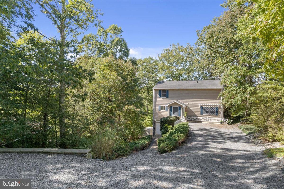 219 Calvert Drive Lusby, MD 20657 - Photo 5 of 51 a front view of a house with garden