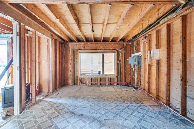 a view of front door with furniture and a window