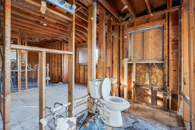 a bathroom with a toilet and shower