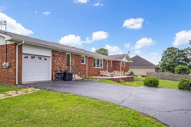 a view of a house with swimming pool and a yard