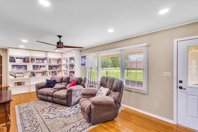 a living room with furniture and a book shelf