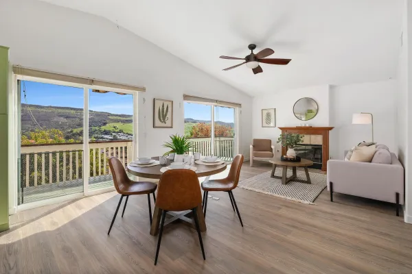 a dining room with furniture a window and wooden floor