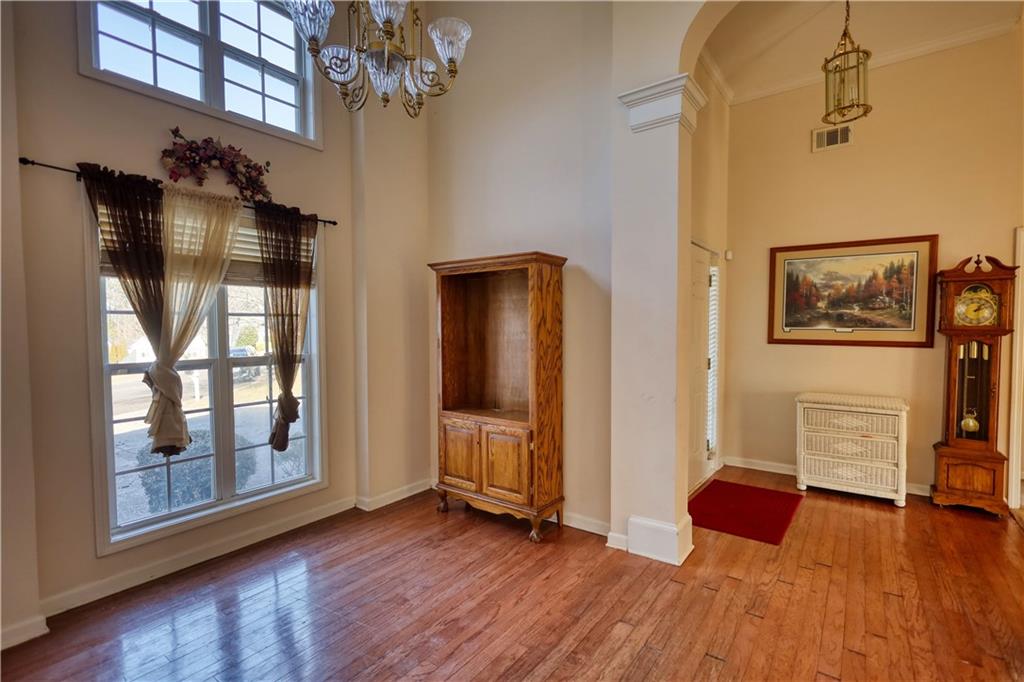 2648 Neighborhood Walk Villa Rica, GA 30180 - Photo 15 of 40 a view of a livingroom with wooden floor and a flat screen tv