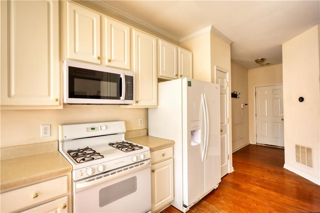 2648 Neighborhood Walk Villa Rica, GA 30180 - Photo 17 of 40 a kitchen with white cabinets and stainless steel appliances