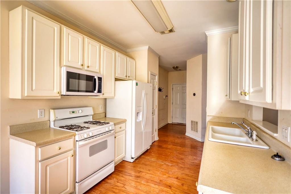 2648 Neighborhood Walk Villa Rica, GA 30180 - Photo 18 of 40 a kitchen with stainless steel appliances a stove a sink and a microwave