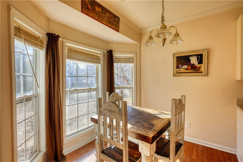 2648 Neighborhood Walk Villa Rica, GA 30180 - Photo 20 of 40 a view of a dining room with furniture wooden floor and a chandelier