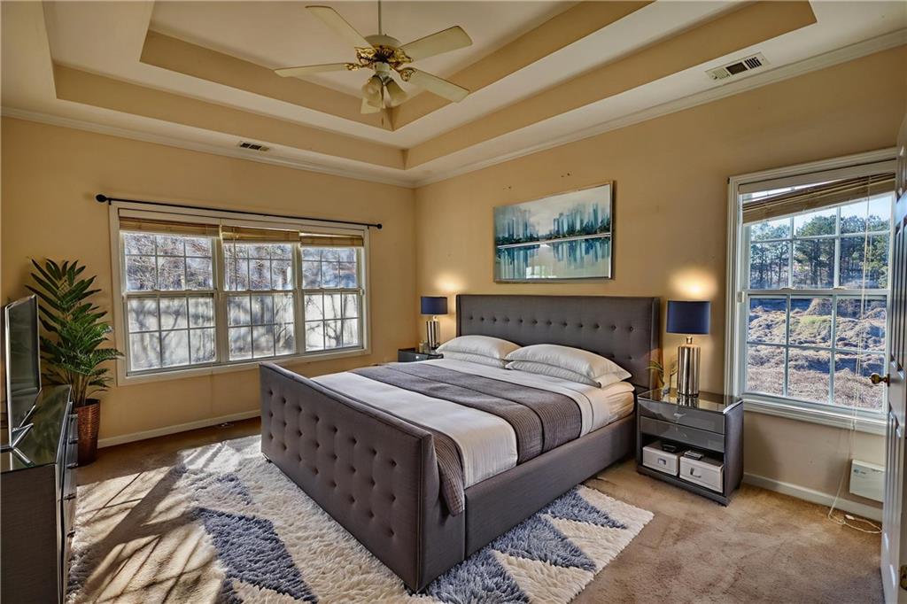 2648 Neighborhood Walk Villa Rica, GA 30180 - Photo 23 of 40 a spacious bedroom with a bed and a window