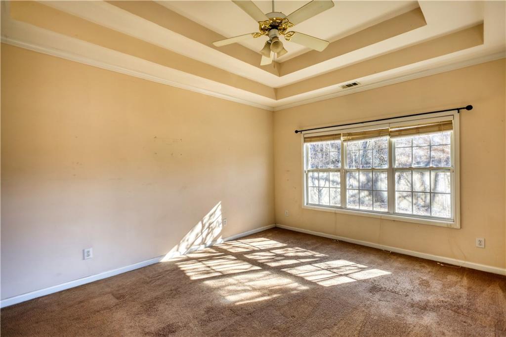 2648 Neighborhood Walk Villa Rica, GA 30180 - Photo 24 of 40 a view of a big room with windows and chandelier fan