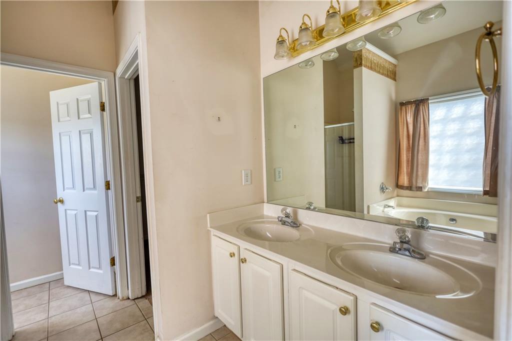 2648 Neighborhood Walk Villa Rica, GA 30180 - Photo 25 of 40 a bathroom with a sink and a mirror